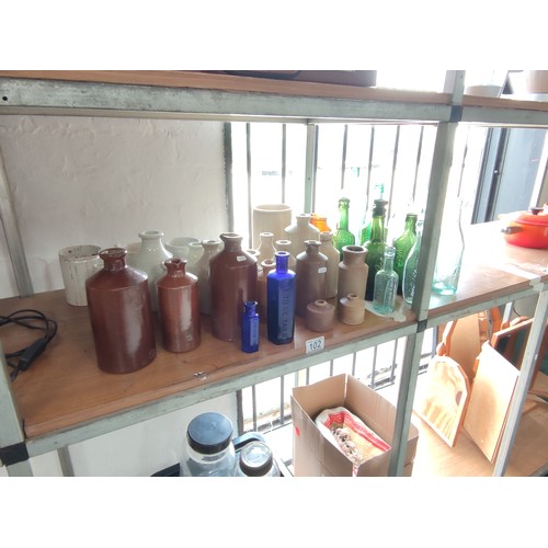 102 - A quantity of collectable earthenware pots and collectable bottles including 2 marble stopper bottle... 