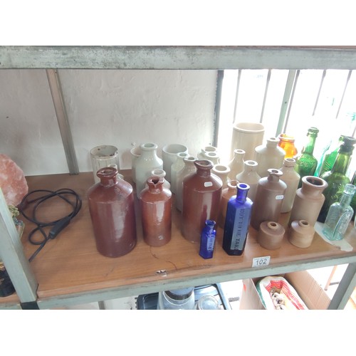 102 - A quantity of collectable earthenware pots and collectable bottles including 2 marble stopper bottle... 