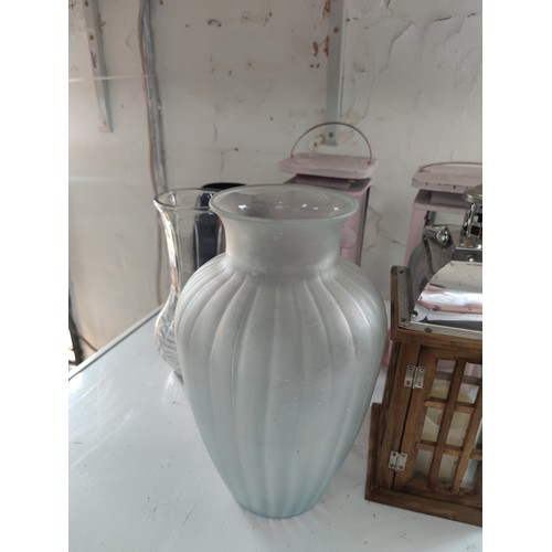 120 - 6 x Pillar candle lanterns some wooden some steel 2 are battery operated with a small qty of vases. ... 