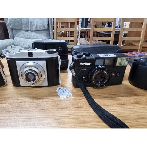 48 - A collection of 7x various vintage cameras to include a Canon EOS 1000F, a Minolta Dynax 500 SI, a V... 