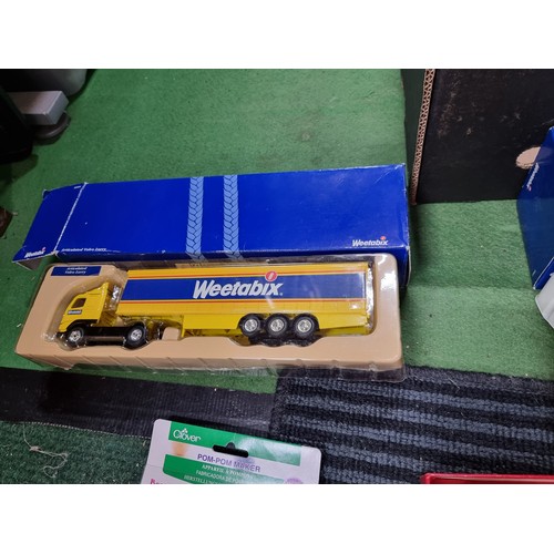 59 - A box of collectables including 2 as new diecast Weetabix lorries, a quantity of new Apple watch str... 