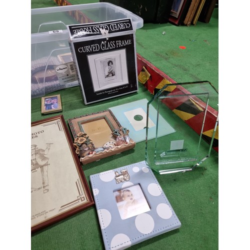 69 - A box full of various photo frames to include thick glass photo frames, glazed picture frames, etc, ... 