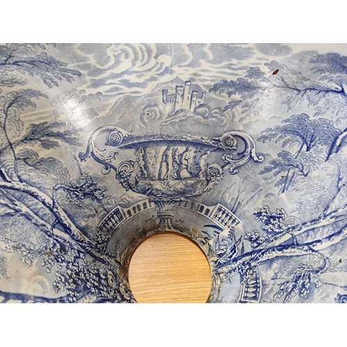 72 - An antique ceramic blue and white toilet bowl, removed from Powis Castle with a intricate scene with... 