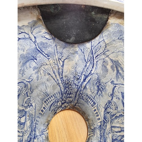 72 - An antique ceramic blue and white toilet bowl, removed from Powis Castle with a intricate scene with... 