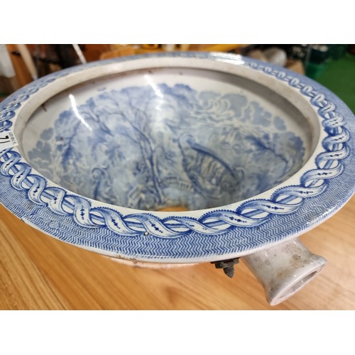 72 - An antique ceramic blue and white toilet bowl, removed from Powis Castle with a intricate scene with... 