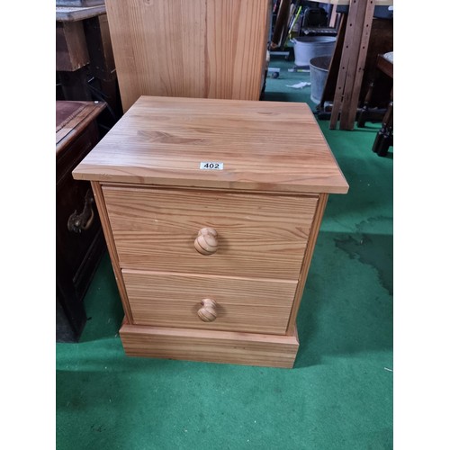 402 - Solid pine bedside table in excellent clean condition with clean top and bun handles height 57 width... 