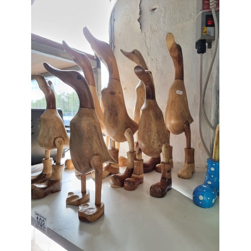 108 - Quantity of 8x fairtrade ducks in boots all new in good order tallest piece measures 39cm high