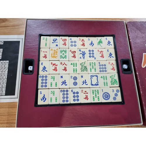 23 - A vintage boxed Mah Jong Chinese game wtih 144 wooden playing pieces and dices .
