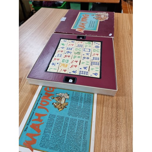 23 - A vintage boxed Mah Jong Chinese game wtih 144 wooden playing pieces and dices .