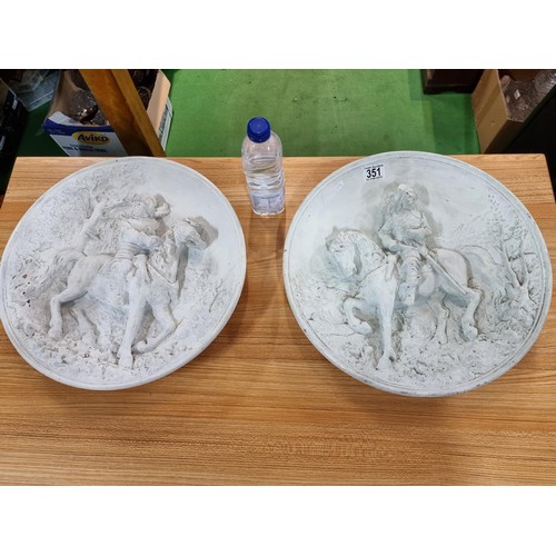 351 - A pair of large chalk 3d chargers with 2 scenes depicting gentlemen on horses, possibly from Don Qui... 