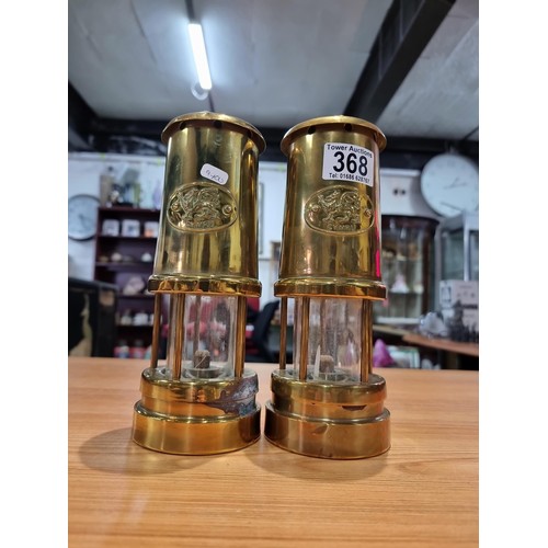 368 - a pair of brass Cymru miners lamps by Nedd products ltd in Glamorgan. Height of 22cm, diameter 9cm.