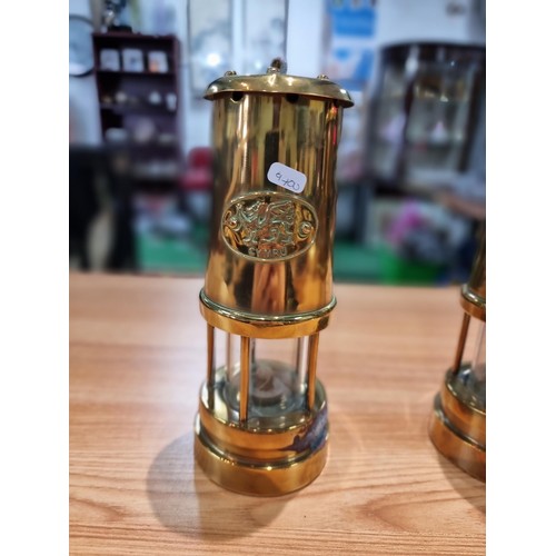 368 - a pair of brass Cymru miners lamps by Nedd products ltd in Glamorgan. Height of 22cm, diameter 9cm.