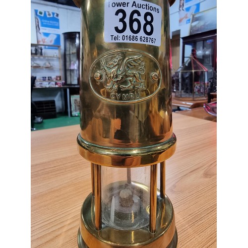 368 - a pair of brass Cymru miners lamps by Nedd products ltd in Glamorgan. Height of 22cm, diameter 9cm.