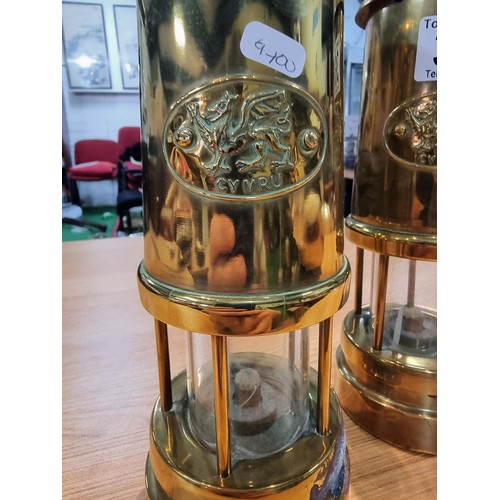 368 - a pair of brass Cymru miners lamps by Nedd products ltd in Glamorgan. Height of 22cm, diameter 9cm.