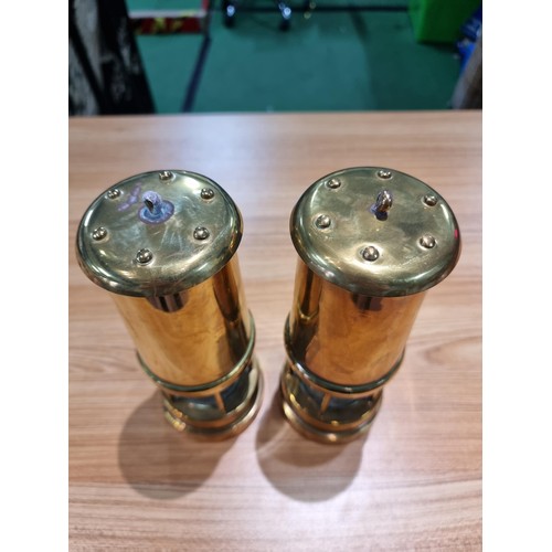 368 - a pair of brass Cymru miners lamps by Nedd products ltd in Glamorgan. Height of 22cm, diameter 9cm.