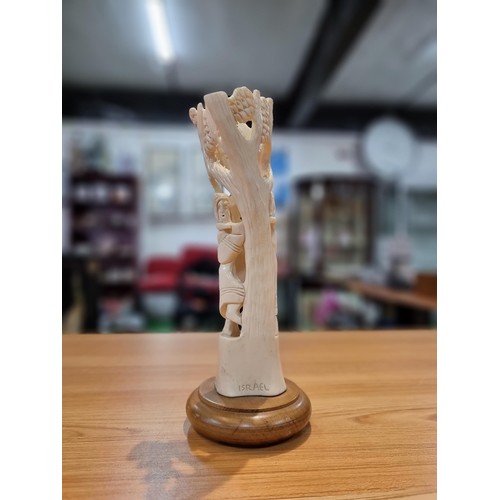 369 - A vintage carved ox bone ornament made in Israel of a scene of two people handling fruit, marked Isr... 