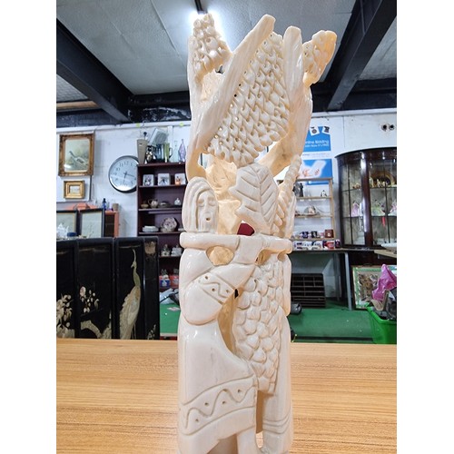 369 - A vintage carved ox bone ornament made in Israel of a scene of two people handling fruit, marked Isr... 