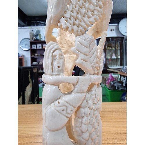 369 - A vintage carved ox bone ornament made in Israel of a scene of two people handling fruit, marked Isr... 