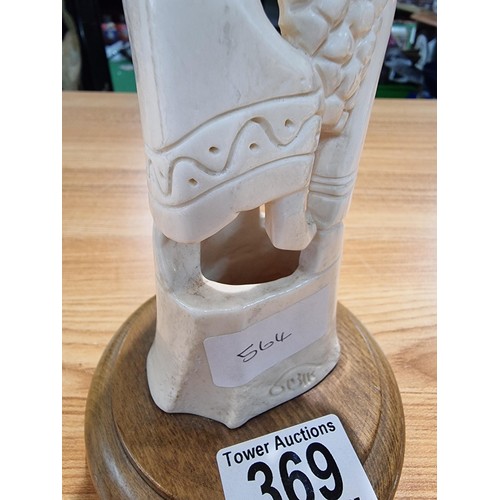 369 - A vintage carved ox bone ornament made in Israel of a scene of two people handling fruit, marked Isr... 