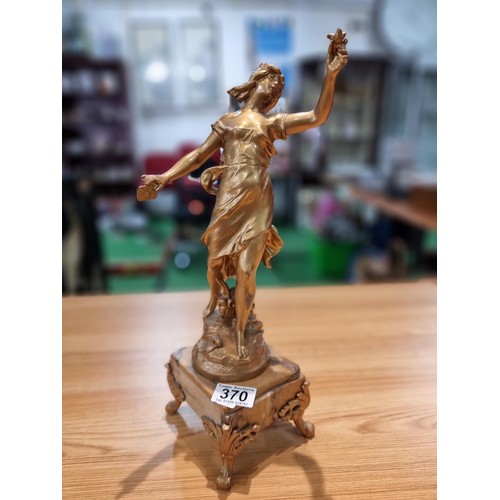 370 - An impressive gilt Spelter figure of a lady holding a dove and a letter in the other hand, set on a ... 