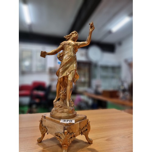 370 - An impressive gilt Spelter figure of a lady holding a dove and a letter in the other hand, set on a ... 