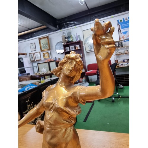 370 - An impressive gilt Spelter figure of a lady holding a dove and a letter in the other hand, set on a ... 