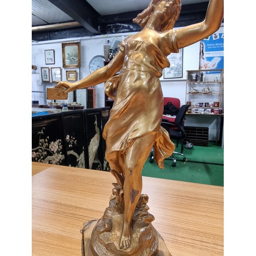 370 - An impressive gilt Spelter figure of a lady holding a dove and a letter in the other hand, set on a ... 