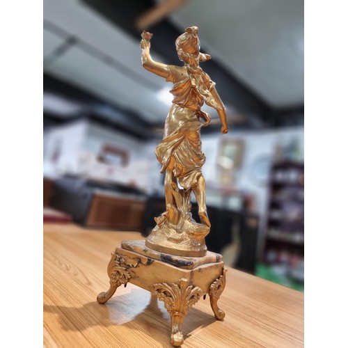 370 - An impressive gilt Spelter figure of a lady holding a dove and a letter in the other hand, set on a ... 