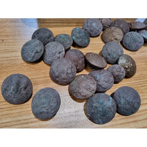 374 - A large collection of vintage military buttons along with a bayonet.
