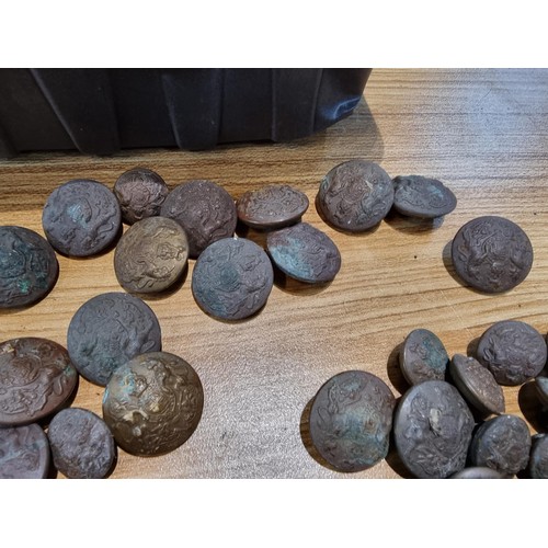 374 - A large collection of vintage military buttons along with a bayonet.