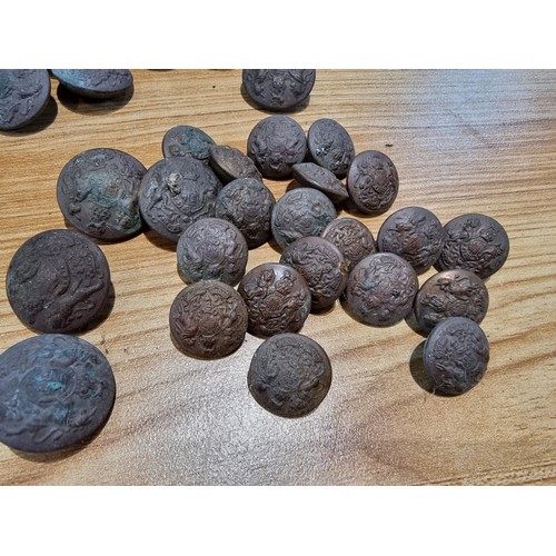 374 - A large collection of vintage military buttons along with a bayonet.