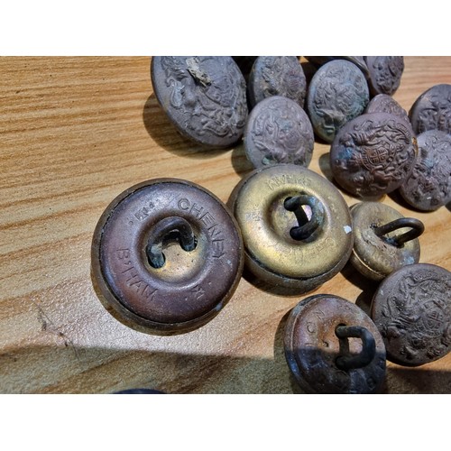 374 - A large collection of vintage military buttons along with a bayonet.