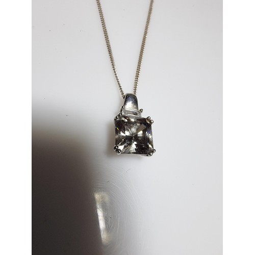375 - A 925 silver pendant inset with a large smoky CZ stone set on  a 18
