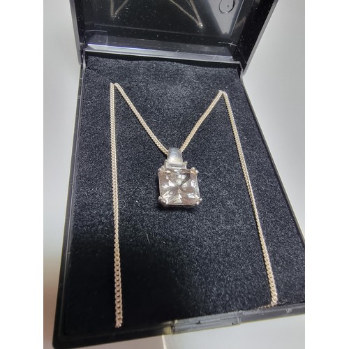 375 - A 925 silver pendant inset with a large smoky CZ stone set on  a 18