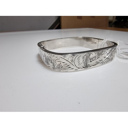 376 - A tested as sterling silver 3 piece bangle, along with an ornate engraved 925 silver hinged bracelet... 