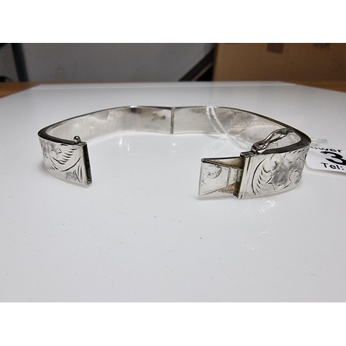376 - A tested as sterling silver 3 piece bangle, along with an ornate engraved 925 silver hinged bracelet... 
