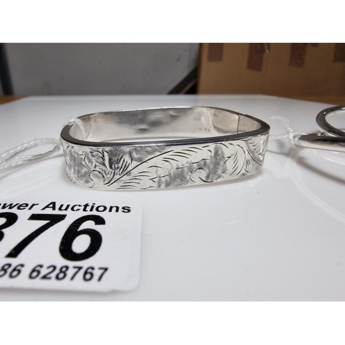 376 - A tested as sterling silver 3 piece bangle, along with an ornate engraved 925 silver hinged bracelet... 