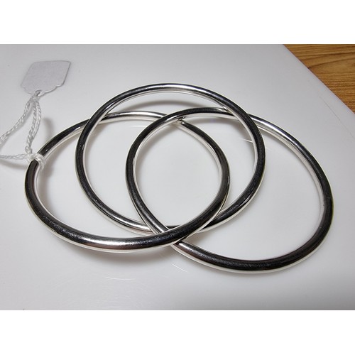 376 - A tested as sterling silver 3 piece bangle, along with an ornate engraved 925 silver hinged bracelet... 