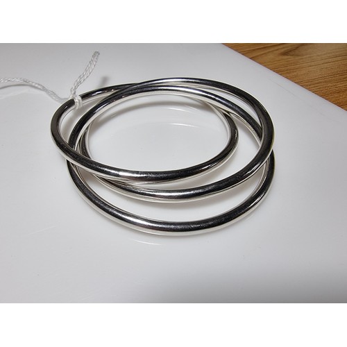 376 - A tested as sterling silver 3 piece bangle, along with an ornate engraved 925 silver hinged bracelet... 
