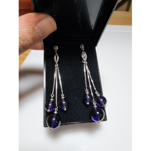 377 - A pair of 925 silver long drop earrings with 3 Amethyst bead ends. Length of the drop is 7cm, in goo... 