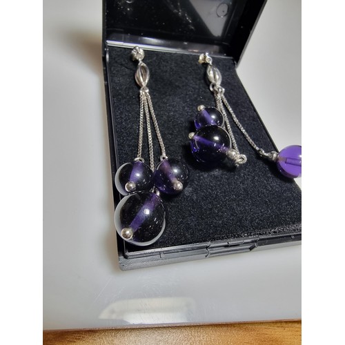 377 - A pair of 925 silver long drop earrings with 3 Amethyst bead ends. Length of the drop is 7cm, in goo... 