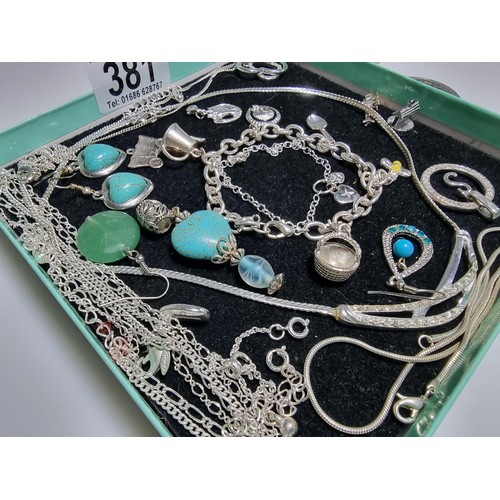 381 - A quantity of various costume jewellery including a charm bracelet, various chains, a 925 silver bra... 