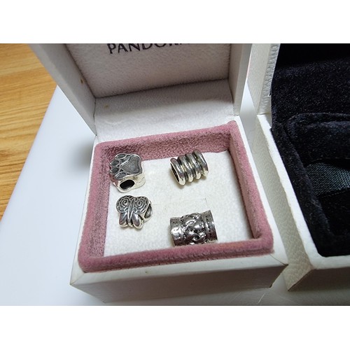 382 - A large collection of various charms including a genuine Pandora silver part charm marked 925 ALE al... 