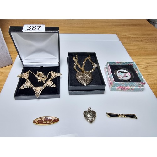 387 - A quantity of various boxed costume jewellery along with a quantity of brooches in clean condition.