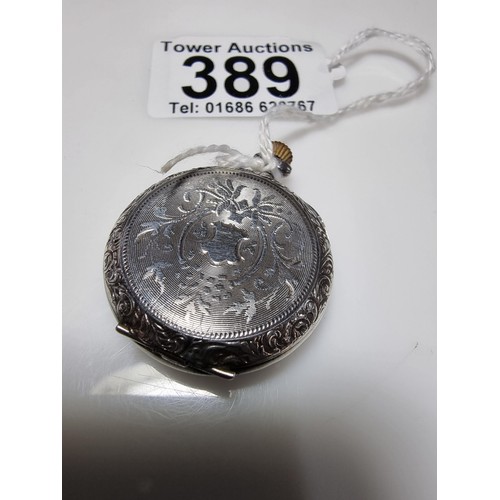 389 - A 925 silver fob watch with an ornate engraved case, the watch glass needs replacing but the dial is... 
