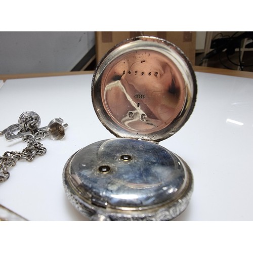 392 - A good quality genuine Swiss 935 silver fob watch with an ornate engraved design featuring an ornate... 