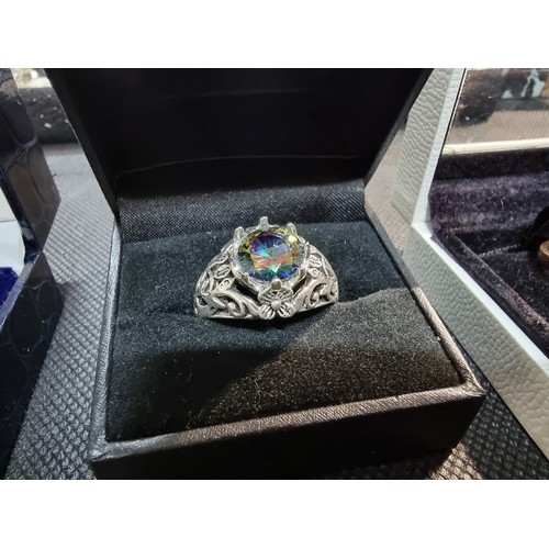 396 - A quantity of boxed dress rings and a silver plated bracelet to include an ornate ring with an aura ... 