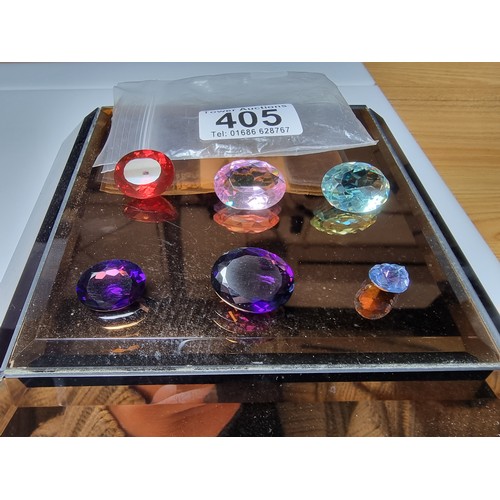 405 - A selection of 6 faceted gemstones to include 2 genuine tested as amethyst faceted gemstones and 4 o... 