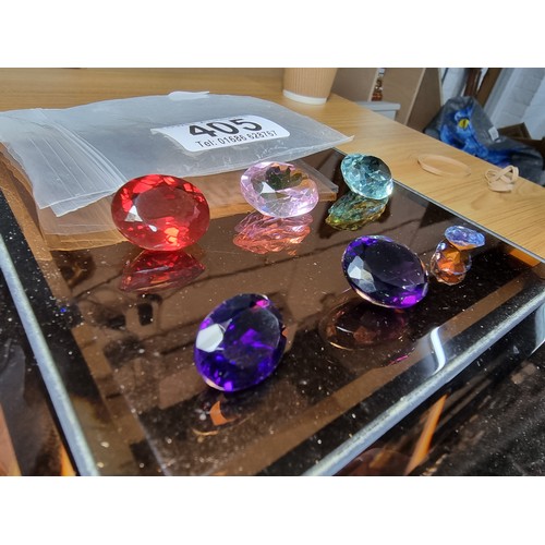 405 - A selection of 6 faceted gemstones to include 2 genuine tested as amethyst faceted gemstones and 4 o... 