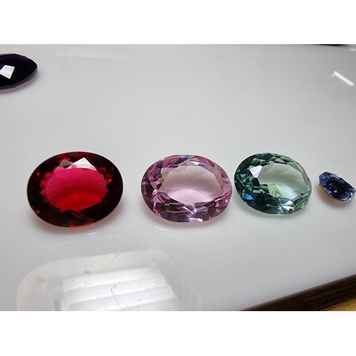 405 - A selection of 6 faceted gemstones to include 2 genuine tested as amethyst faceted gemstones and 4 o... 